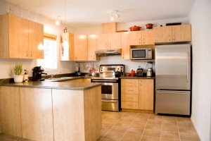 A modern kitchen with a stylish kitchen set, featuring sleek countertops and contemporary appliances